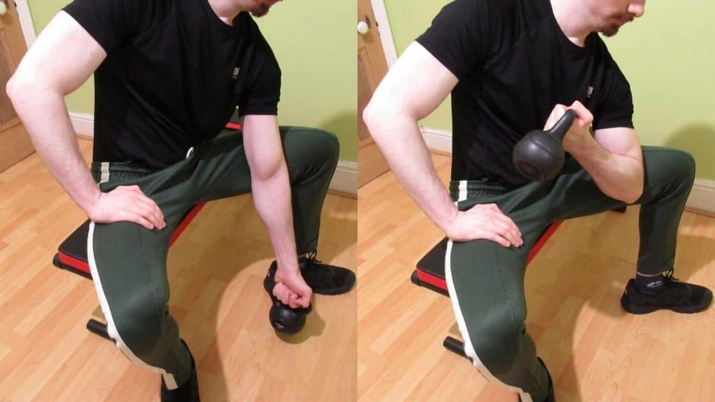 A man performing concentration kettlebell curls