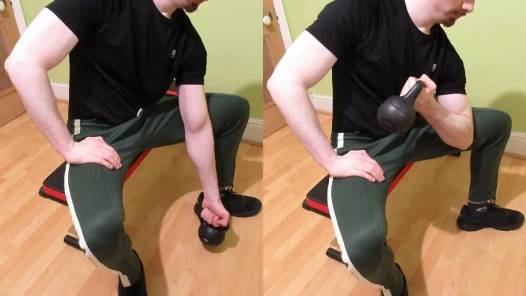 A man performing concentration kettlebell curls