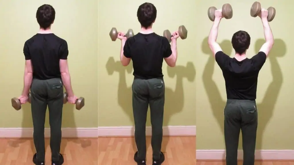 A man doing the DB curl to press exercise