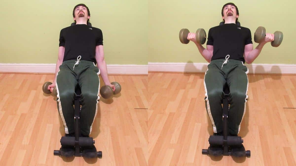 A man performing a DB incline curl to work his biceps