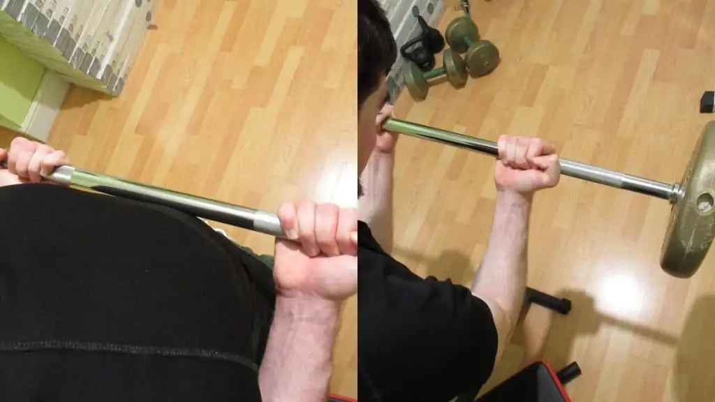 A man showing that you can do a drag curl or spider curl to work your biceps