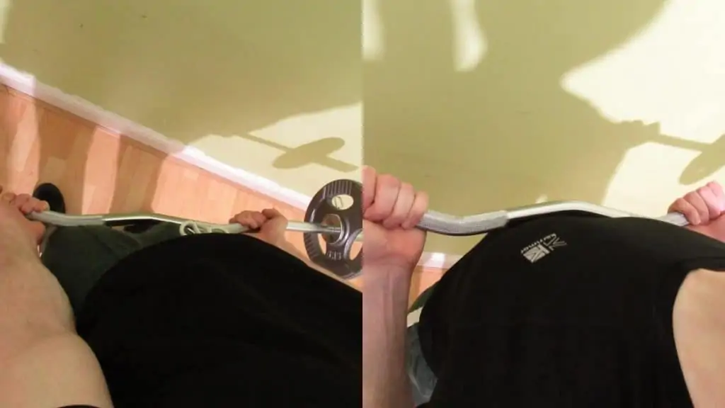 A man doing drag EZ bar curls