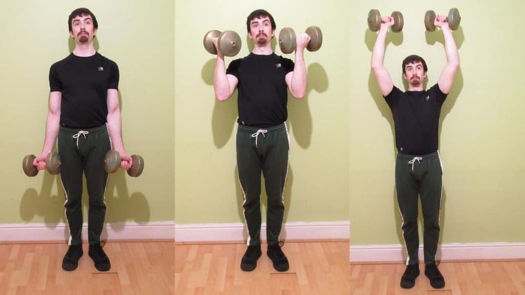 A man doing a dumbbell curl to press exercise for his shoulders