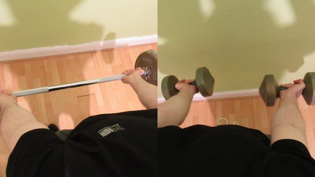 A man performing a dumbbell curl vs barbell curl comparison to illustrate the differences