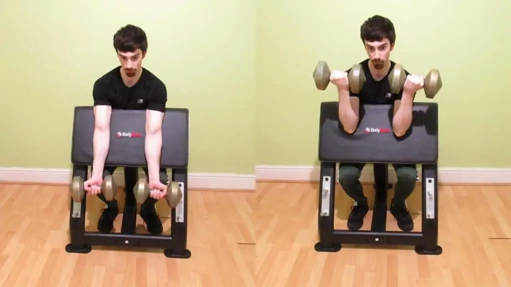 A man doing a dumbbell preacher curl for his biceps