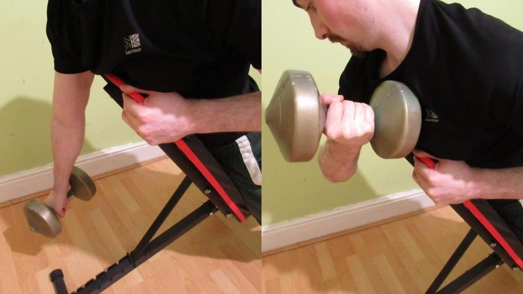 A man doing a dumbbell prone incline curl
