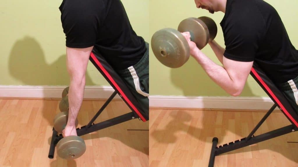 A man doing a dumbbell spider curl to work his biceps