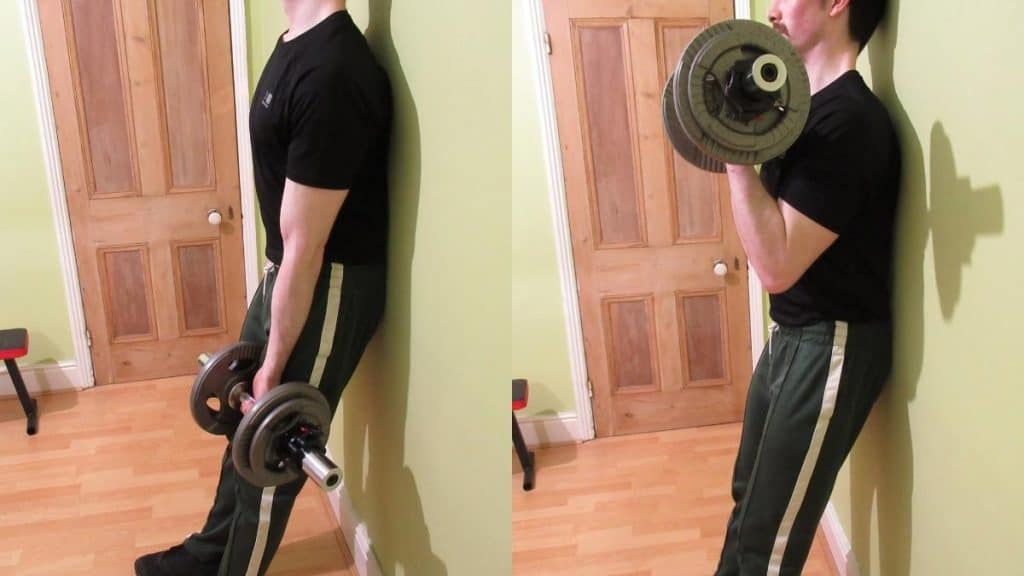 A man performing a one arm dumbbell strict curl to work his biceps