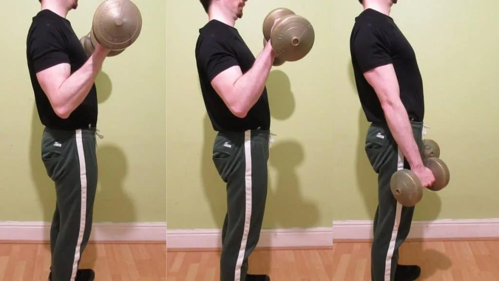 A man performing a standing dumbbell Zottman curl to work his biceps