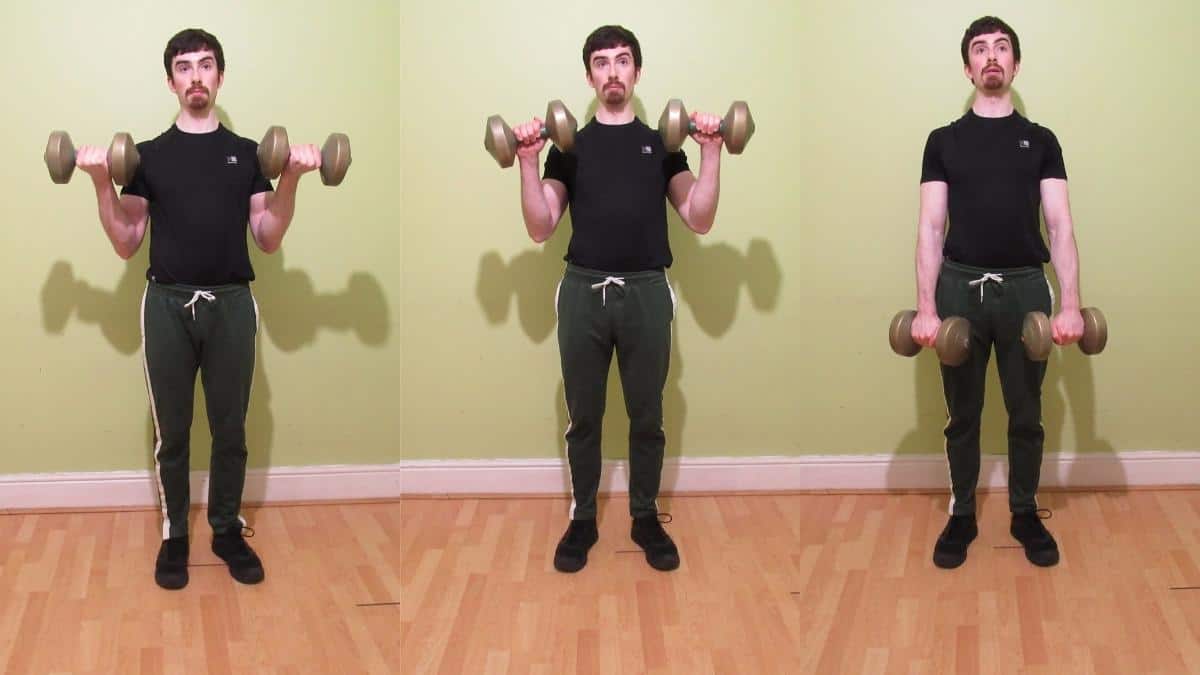 A man doing standing dumbbell Zottman curls for his biceps