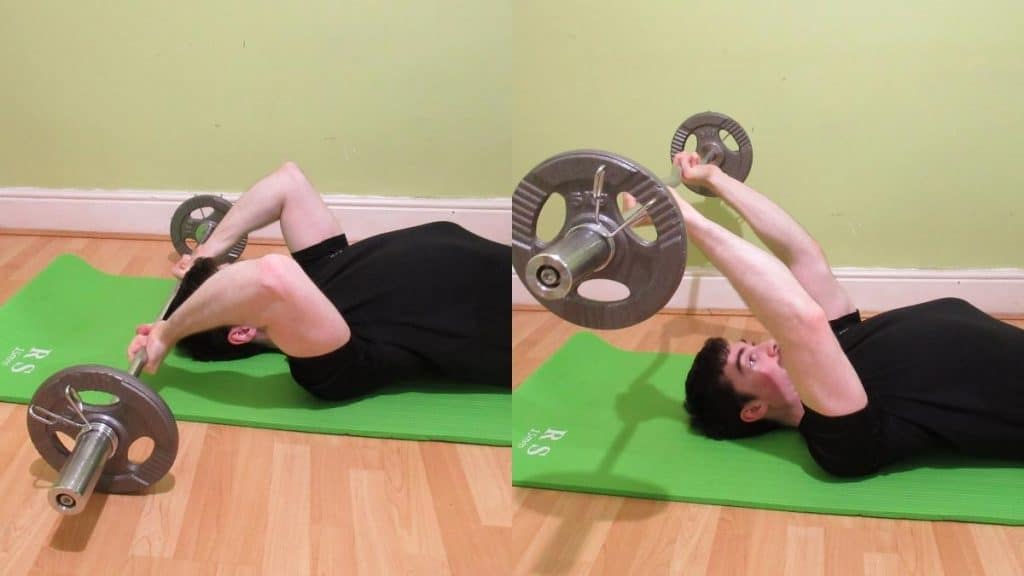 A man doing a floor lying tricep extension with a bar