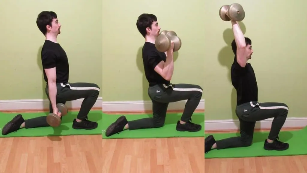 A man performing a half kneeling curl to press