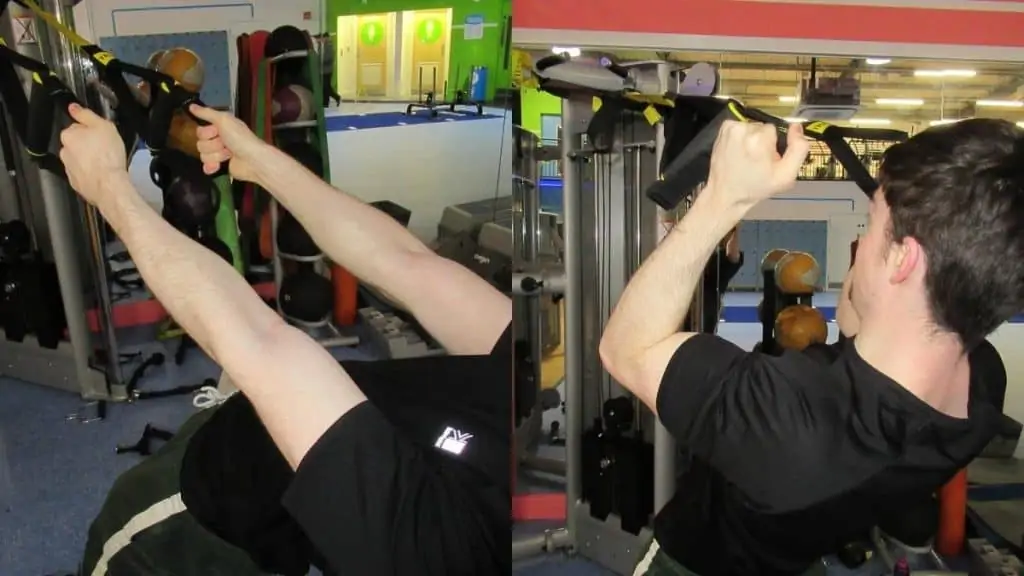 A man doing hammer curls on the TRX