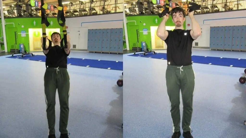 A man doing TRX hammer curls with his suspension trainer