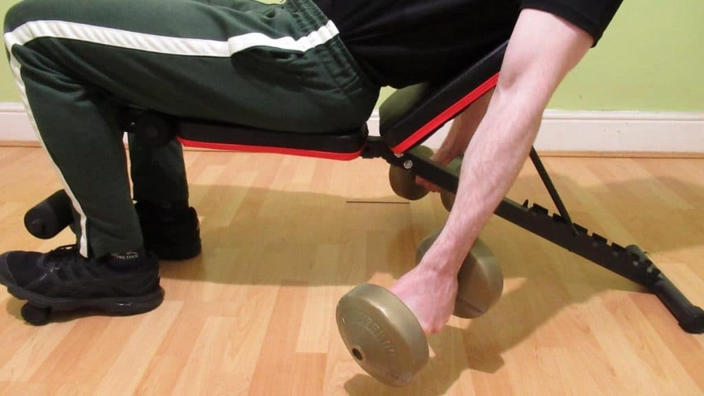 A man performing incline bench hammer curls