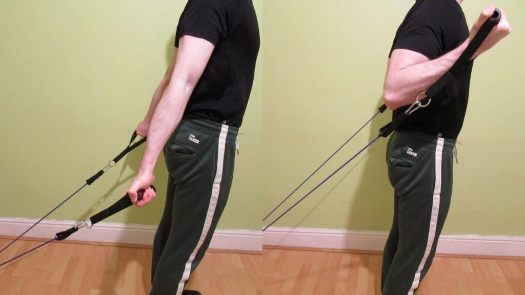 A man performing incline curls with resistance bands