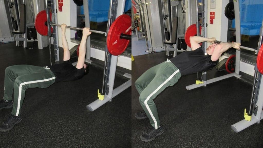 A man at the gym doing inverted curls for his biceps