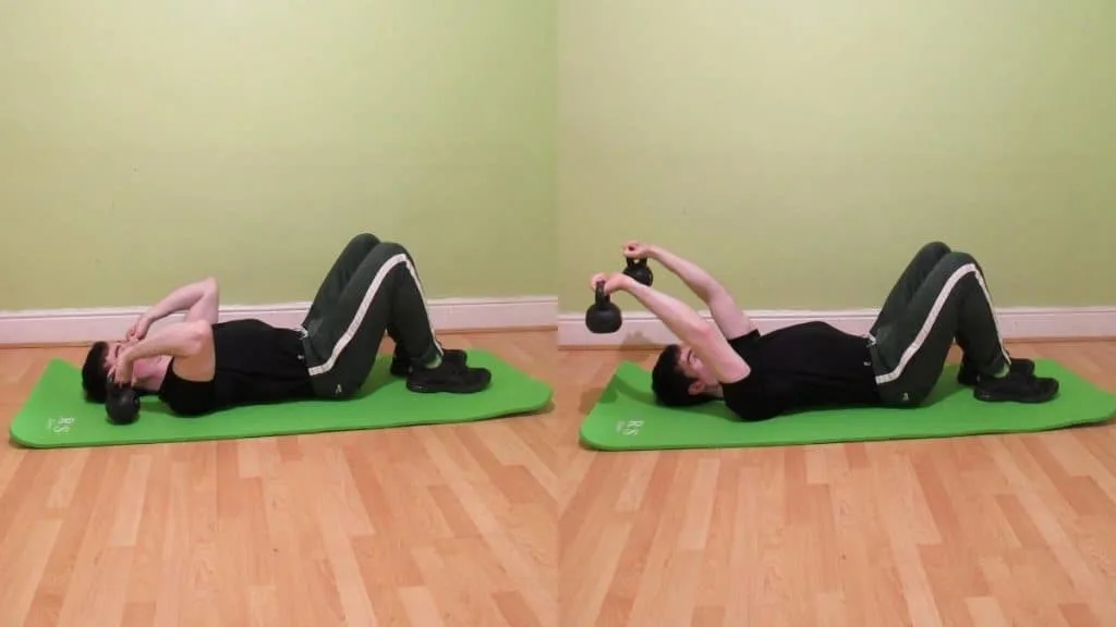 A man performing a kettlebell floor skullcrusher