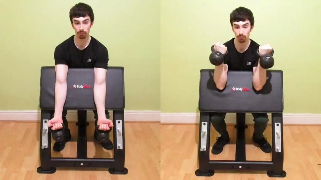 A man performing a kettlebell preacher curl to work his biceps