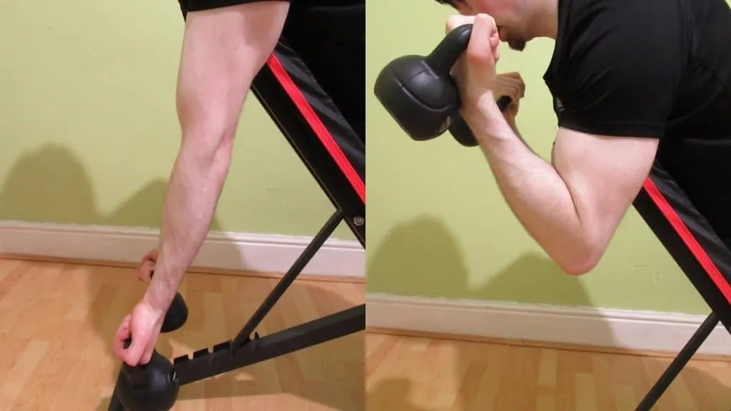 A man performing a kettlebell spider curl to work his biceps