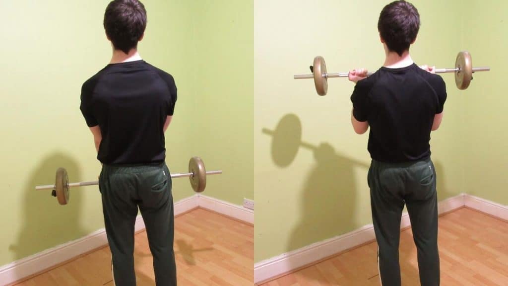 A man doing a narrow grip barbell curl for his biceps
