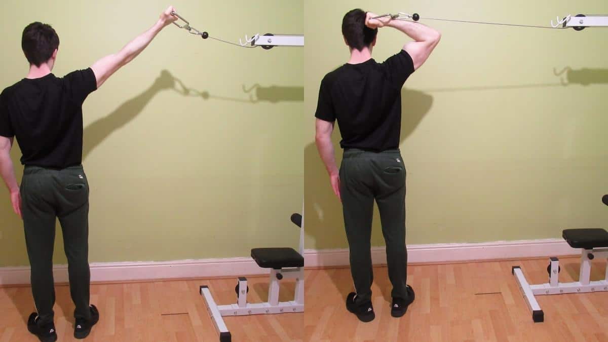A man doing a one arm high cable curl to work his biceps