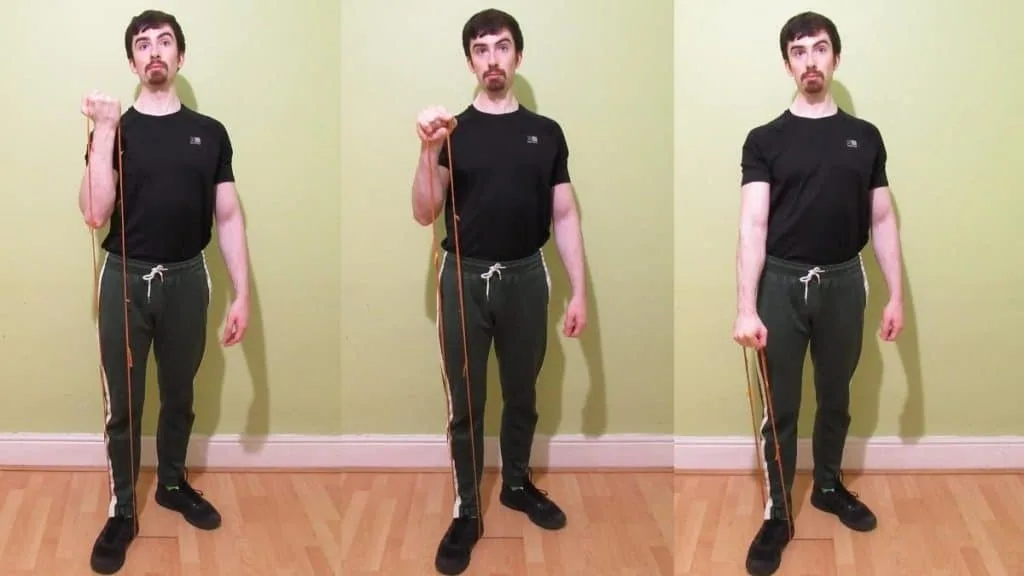 A man doing a one arm resistance band Zottman curl