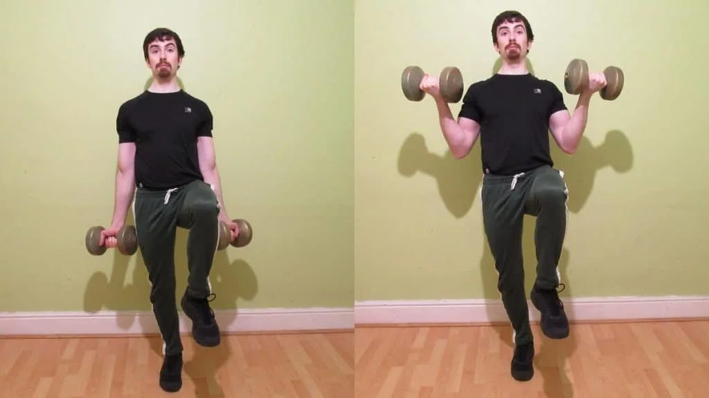 A man doing a one leg bicep curl with a single dumbbell