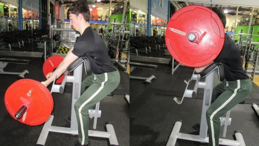 A man performing a preacher curl standing up