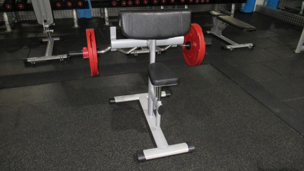 The setup for doing a preacher curl standing up