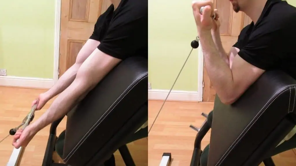 A man performing preacher curls with cables