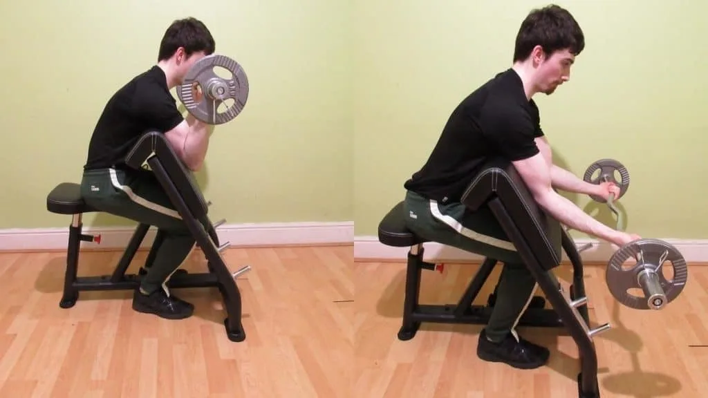 A man doing some preacher curls with a wide grip