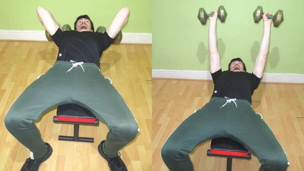 A man performing a pronated skull crusher with some dumbbells