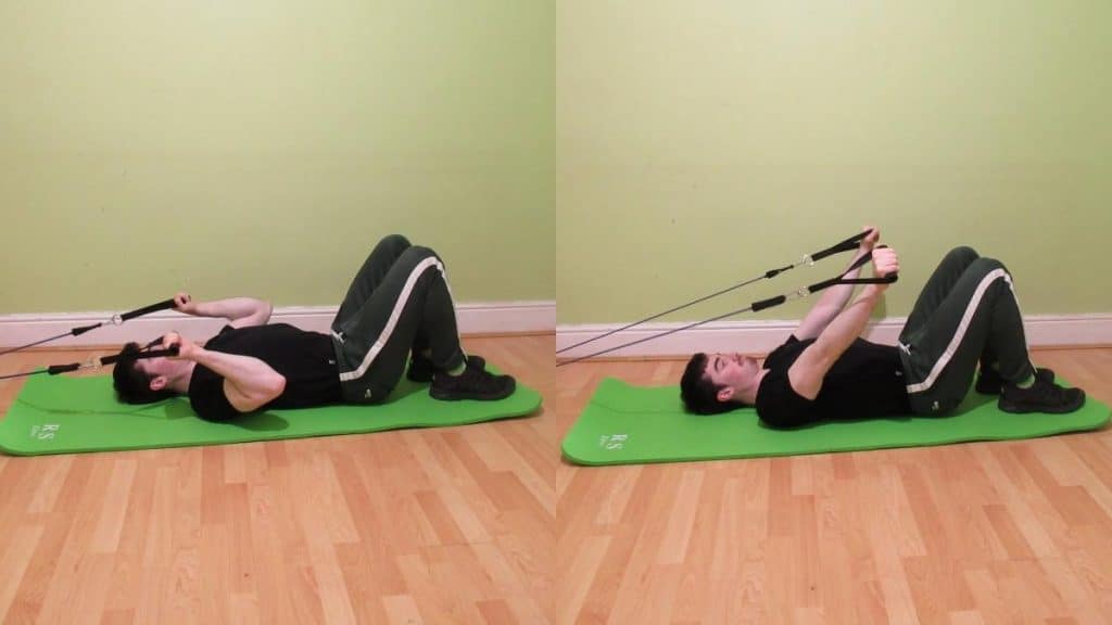 A man doing a resistance band floor skull crusher
