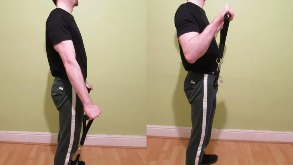 A man doing resistance band reverse curls for his biceps