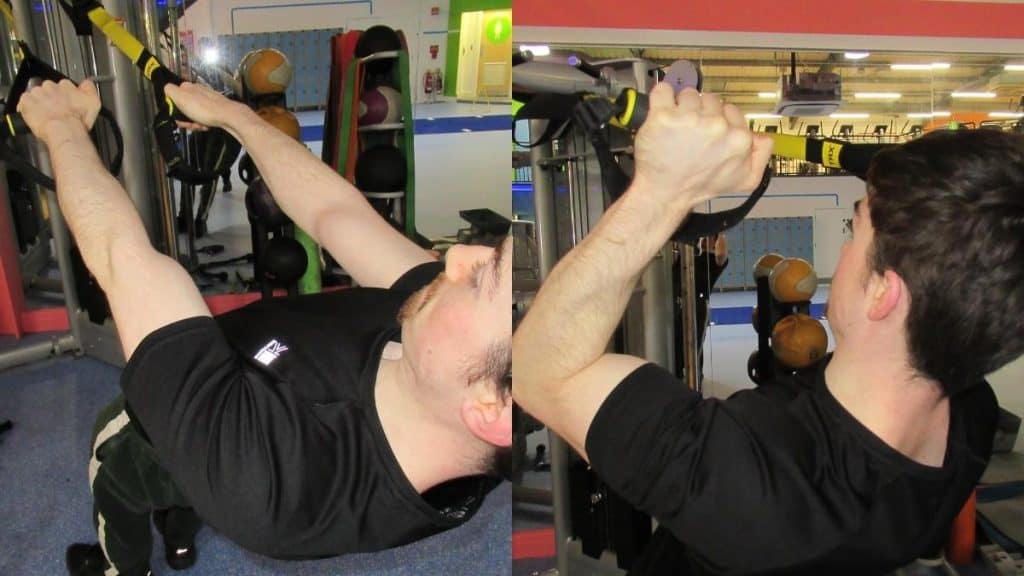 A man doing reverse curls on a TRX suspension trainer