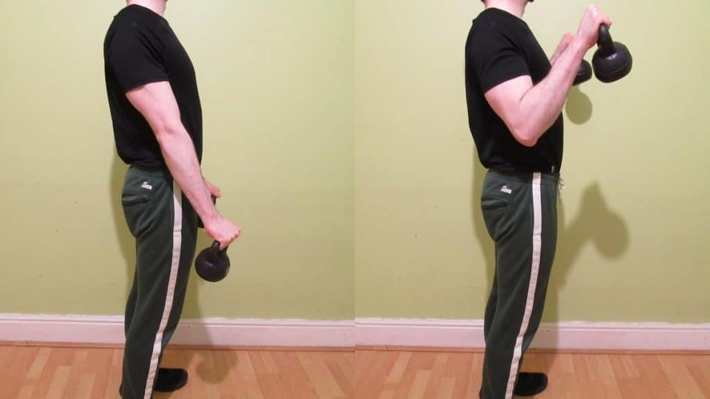 A man performing reverse curls with kettlebells