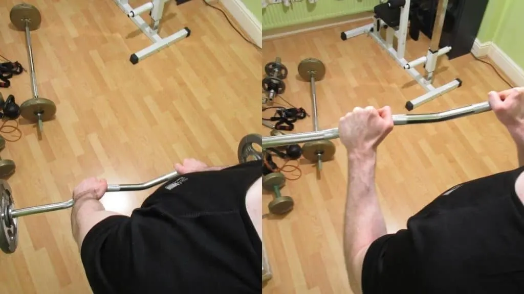 A man performing reverse grip EZ bar curls