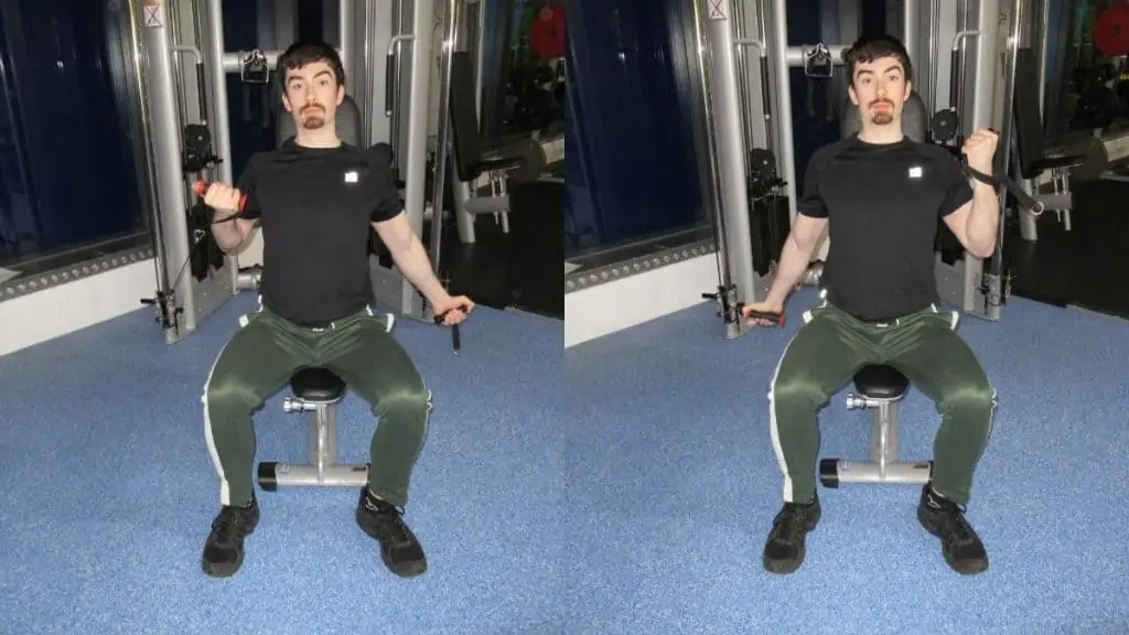 A man doing seated alternating cable curls for his biceps