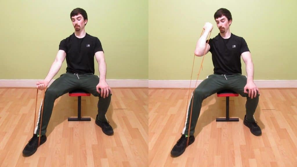 A man doing a seated bicep curl with a resistance band