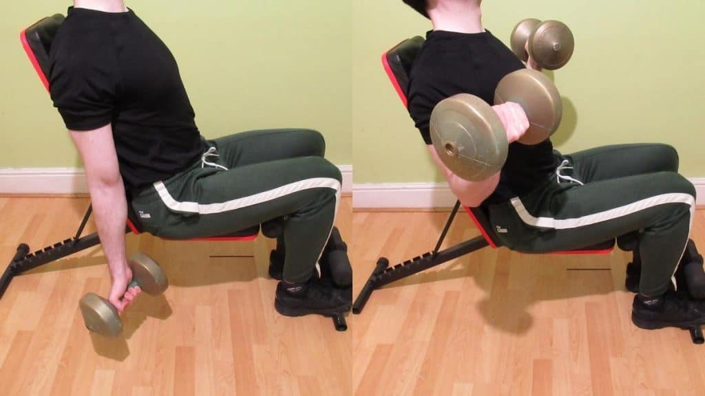 A man doing a seated dumbbell curl to work his biceps
