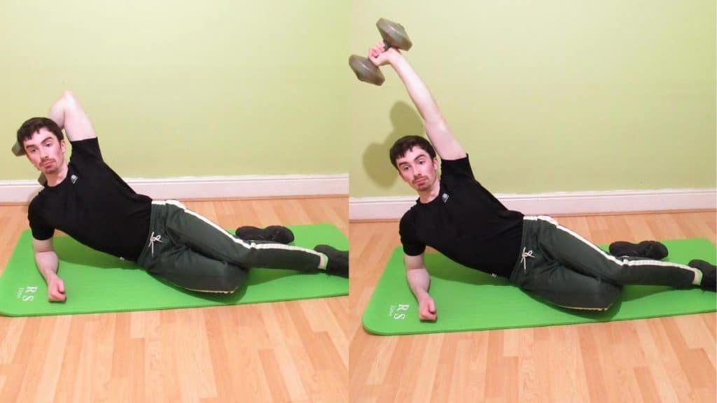 A man performing a dumbbell side leaning tricep extension on a mat