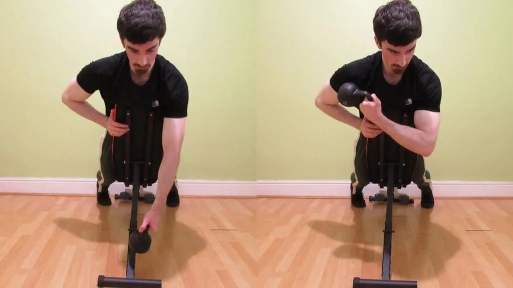 A man doing a single arm kettlebell spider curl