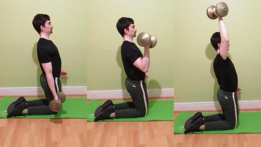 A man doing a single arm kneeling curl to press