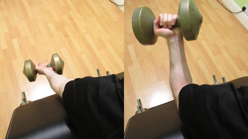 A man doing a single arm preacher curl with one dumbbell