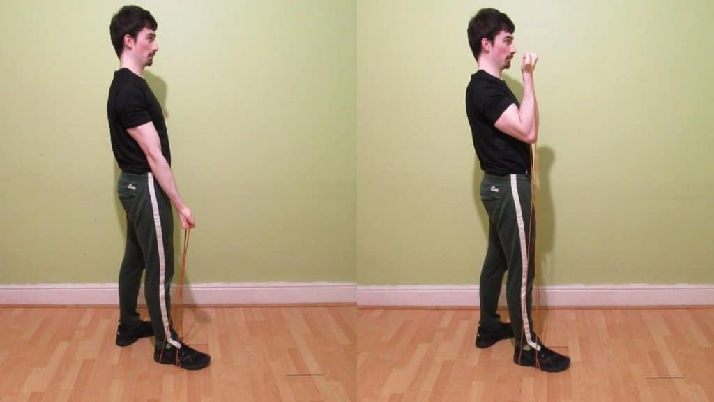 A man doing a single arm resistance band curl for his biceps