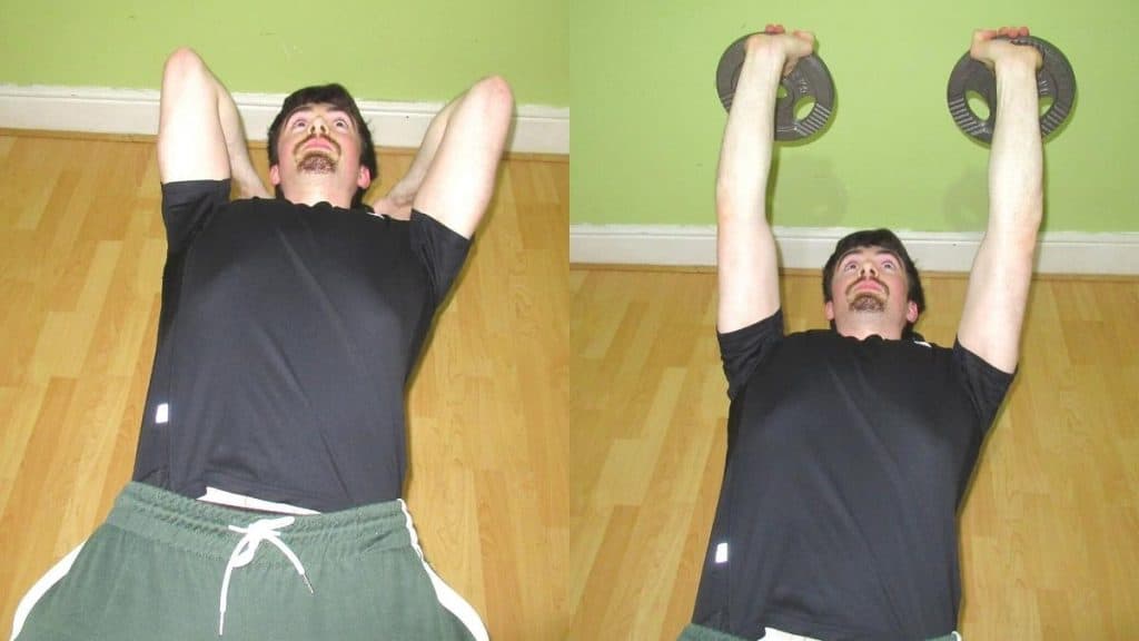 A man performing some skull crushers with a weight plate