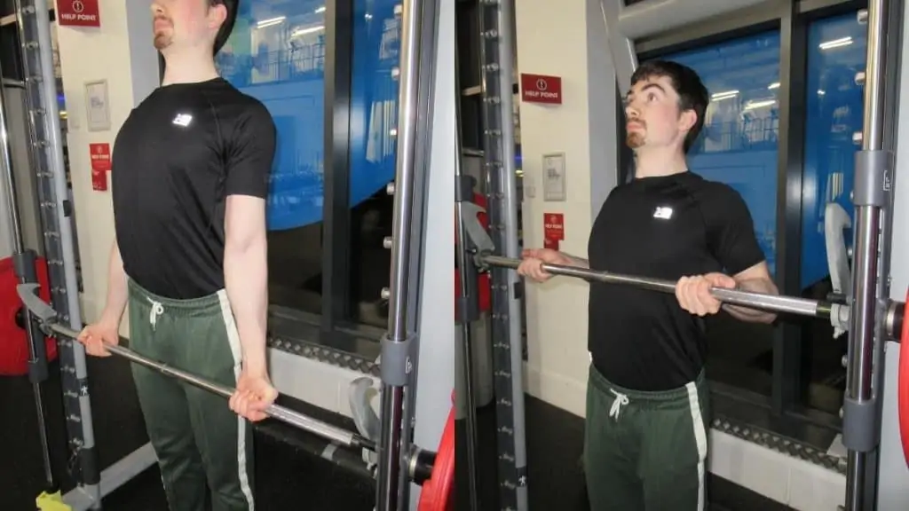 A man doing Smith machine drag curls for his biceps