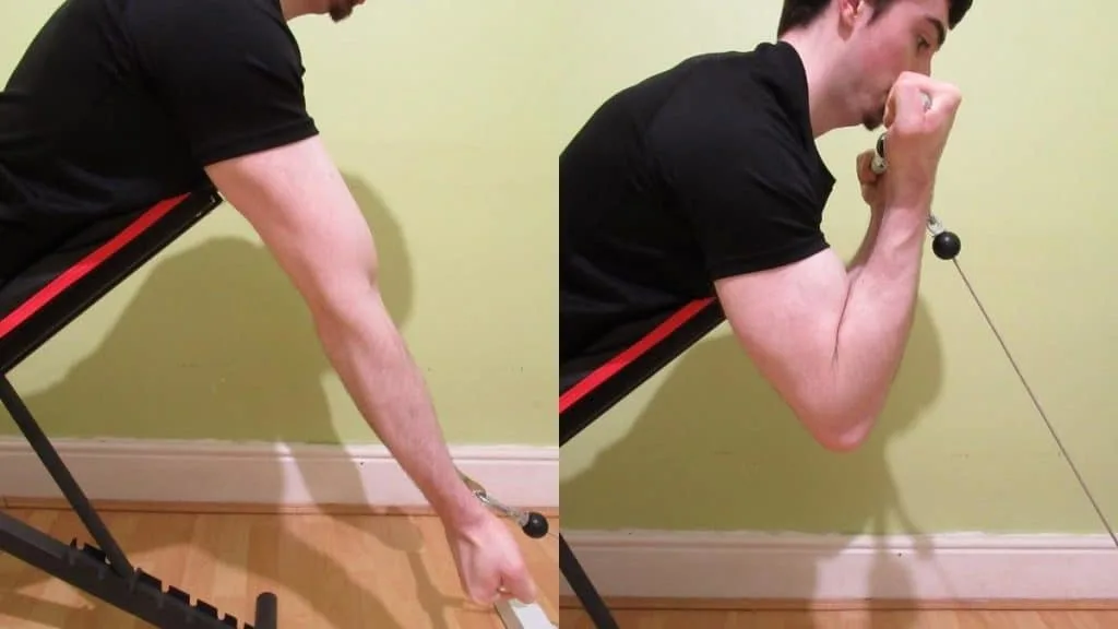 A man doing spider curls with cables