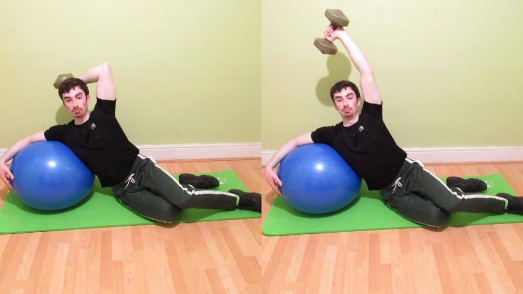 A man performing a stability ball side leaning tricep extension
